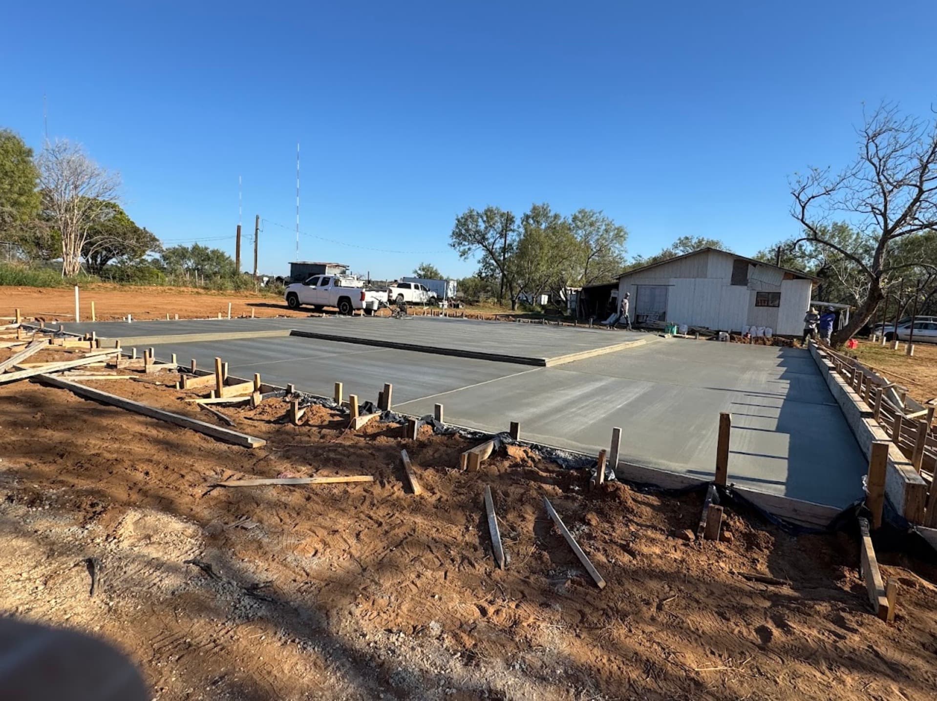 Large freshly poured concrete slab foundation completed by Folsom Construction LLC in the New Braunfels area